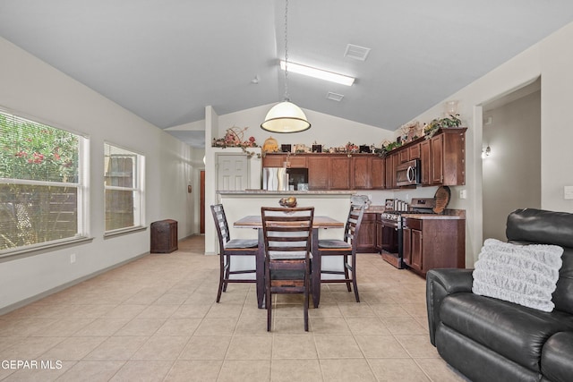 dining space featuring lofted ceiling, light tile patterned floors, and visible vents