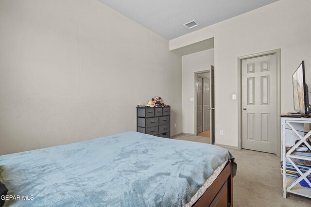 bedroom featuring light colored carpet, visible vents, and baseboards