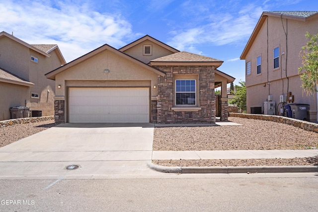 view of front of home with concrete driveway, a garage, stucco siding, and stone siding