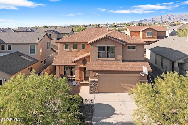 7337 Autumn Sage Dr, El Paso, TX 79911 - traditional-style house featuring a residential view, stucco siding, driveway, a garage, and a mountain view