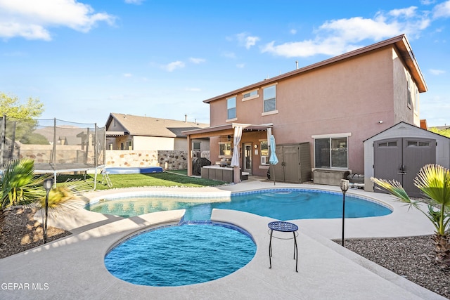 7337 Autumn Sage Dr, El Paso, TX 79911 - view of pool featuring a shed, a trampoline, a fenced backyard, a pool with connected hot tub, and a patio