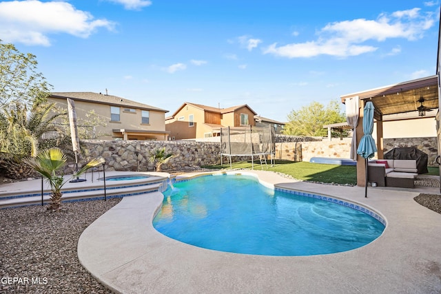 7337 Autumn Sage Dr, El Paso, TX 79911 - view of pool with a trampoline, a fenced backyard, outdoor lounge area, a patio area, and a pool with connected hot tub
