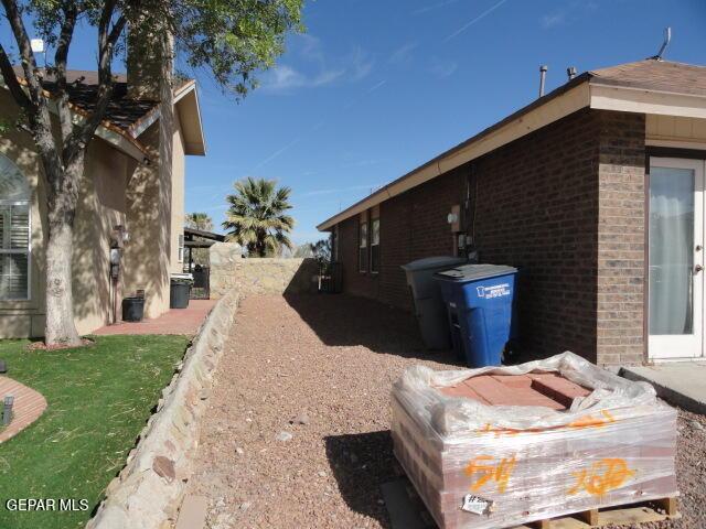 view of side of property featuring brick siding