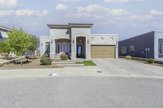 668 Darlington, El Paso, TX 79928 - view of front of home featuring stone siding, a garage, stucco siding, and decorative driveway