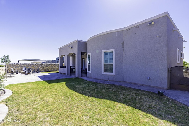 668 Darlington, El Paso, TX 79928 - back of property with a patio, stucco siding, a lawn, and fence