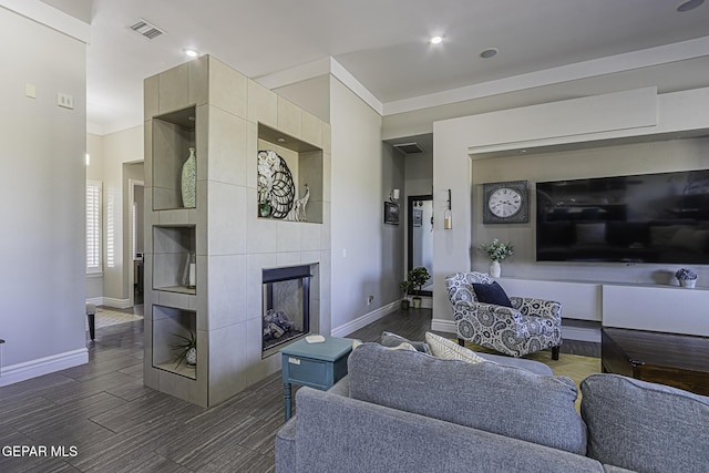 668 Darlington, El Paso, TX 79928 - living area with dark wood-type flooring, visible vents, a fireplace, crown molding, and baseboards