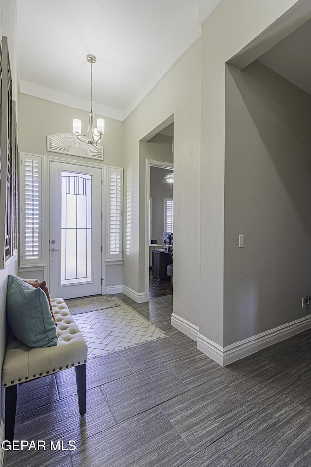 668 Darlington, El Paso, TX 79928 - entrance foyer with a chandelier, crown molding, and baseboards