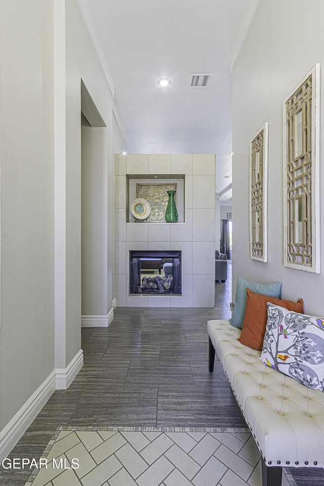668 Darlington, El Paso, TX 79928 - tiled living room featuring a tile fireplace, visible vents, and baseboards