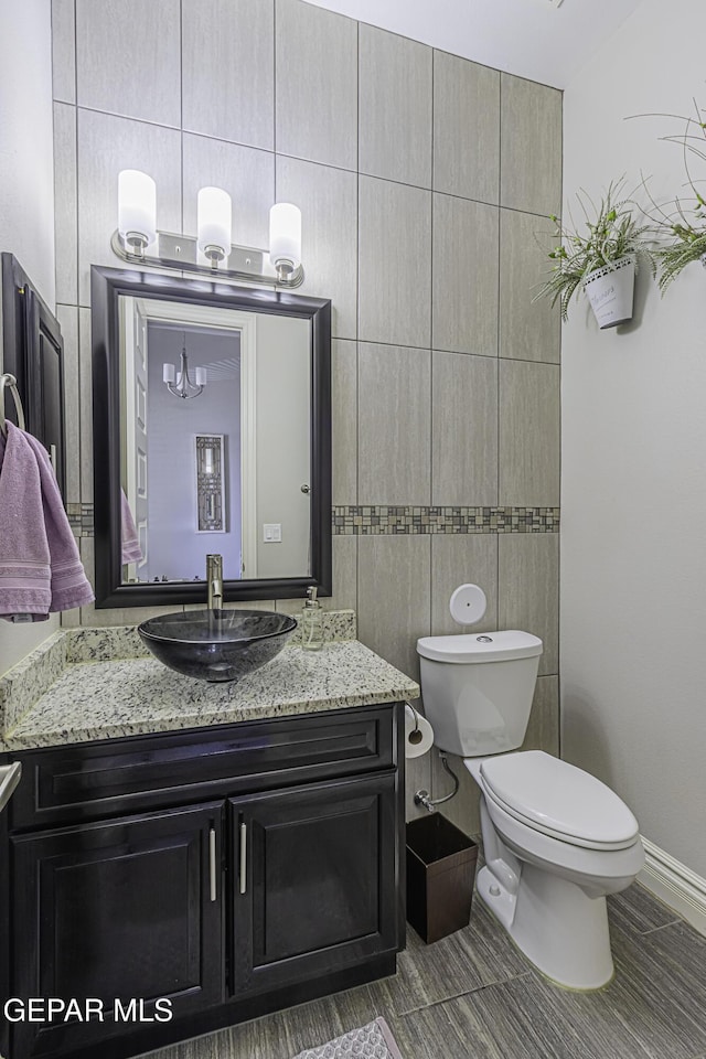 668 Darlington, El Paso, TX 79928 - bathroom featuring vanity, toilet, tile walls, and tile patterned floors