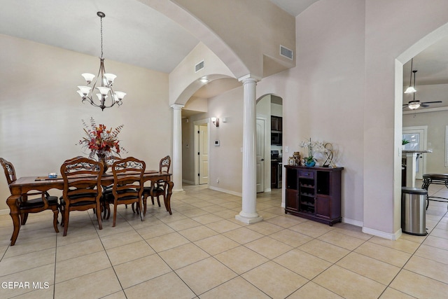 dining area with light tile patterned flooring, visible vents, baseboards, and arched walkways