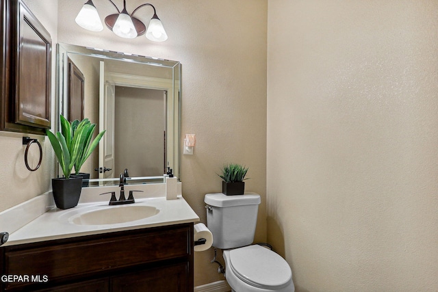 half bathroom featuring toilet and vanity