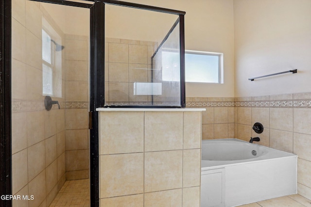 bathroom with a garden tub and a stall shower