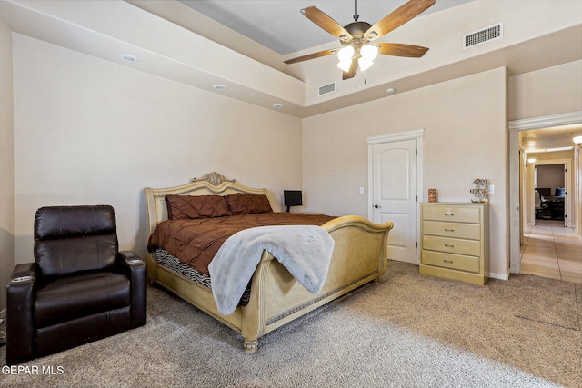carpeted bedroom featuring visible vents and ceiling fan