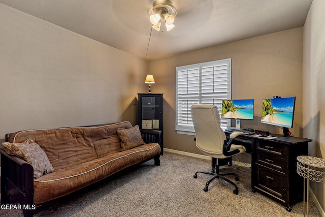 office area featuring baseboards, light carpet, and ceiling fan