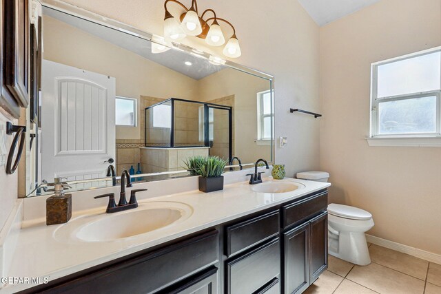 bathroom with a wealth of natural light, a shower stall, and a sink