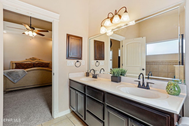 bathroom featuring a ceiling fan, tile patterned flooring, double vanity, and a sink
