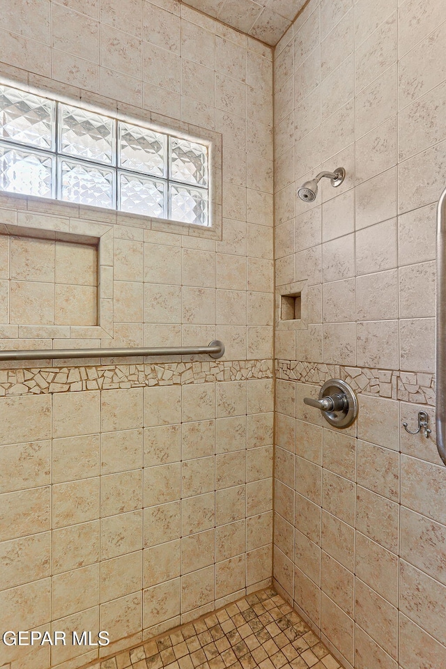 full bath featuring a tile shower