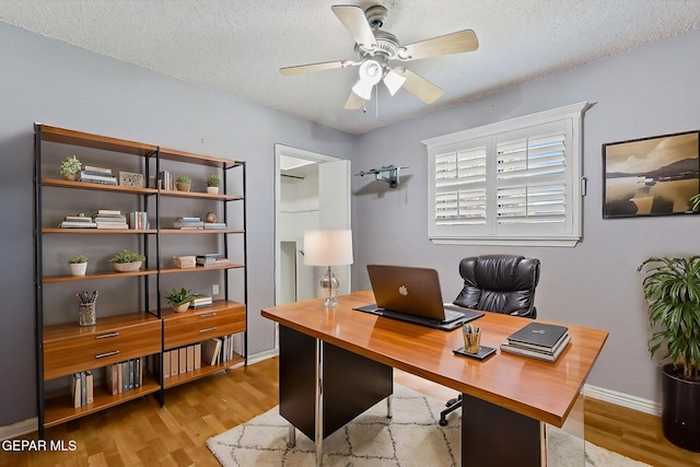 office with baseboards, a textured ceiling, ceiling fan, and wood finished floors