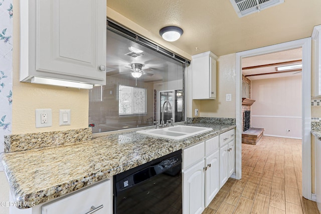 kitchen featuring visible vents, ceiling fan, white cabinetry, a sink, and dishwasher