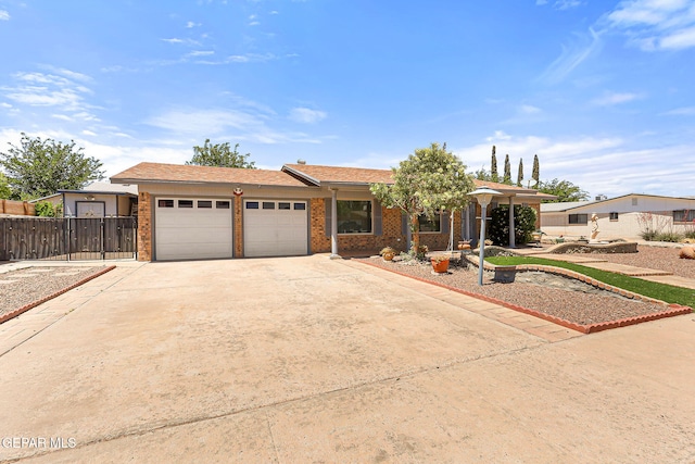 ranch-style home featuring concrete driveway, brick siding, an attached garage, and fence
