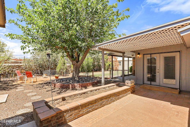 view of patio / terrace featuring fence and french doors