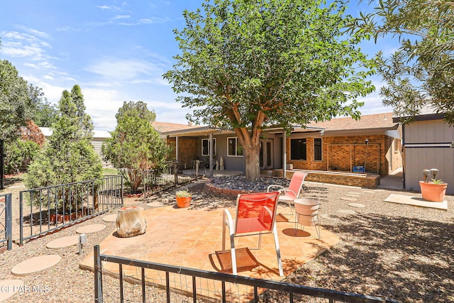back of house with fence and a patio area