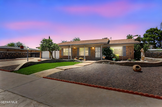 single story home featuring brick siding, a garage, and concrete driveway