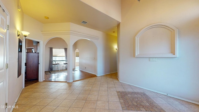2088 Crystal Ridge St, El Paso, TX 79938 - foyer entrance with arched walkways, baseboards, visible vents, and light tile patterned floors