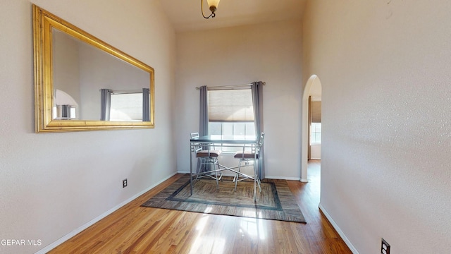 2088 Crystal Ridge St, El Paso, TX 79938 - hallway featuring baseboards, arched walkways, and wood finished floors