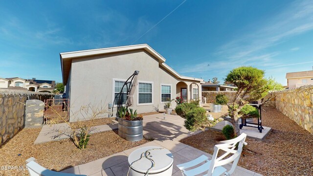 2088 Crystal Ridge St, El Paso, TX 79938 - back of house featuring a fenced backyard, a patio area, and stucco siding