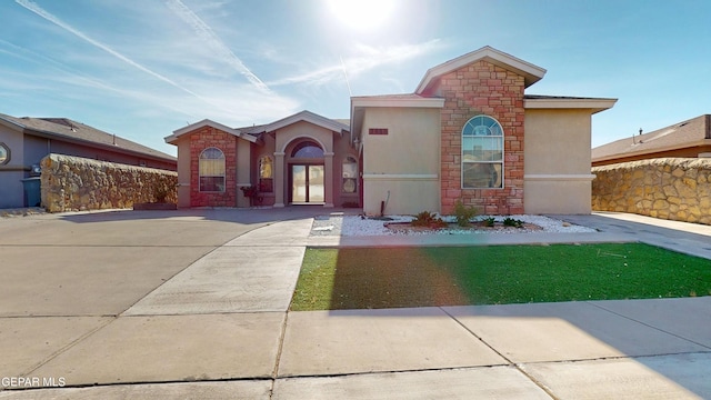 2088 Crystal Ridge St, El Paso, TX 79938 - view of front of home with fence, stone siding, and stucco siding