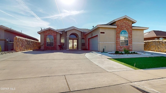 2088 Crystal Ridge St, El Paso, TX 79938 - view of front of property with driveway, a garage, fence, stone siding, and stucco siding