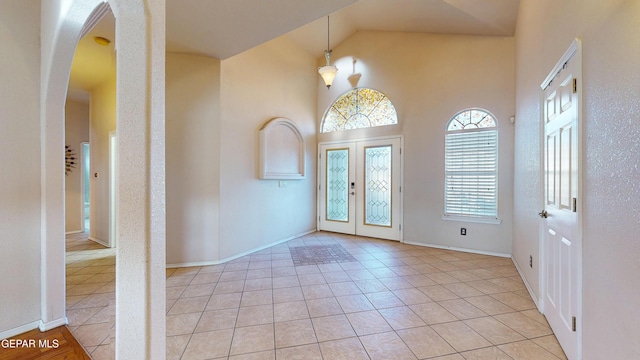 2088 Crystal Ridge St, El Paso, TX 79938 - entryway with french doors, arched walkways, baseboards, and light tile patterned flooring