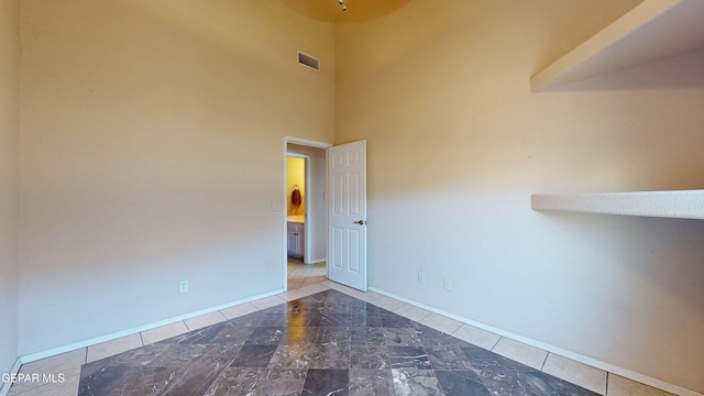 2088 Crystal Ridge St, El Paso, TX 79938 - spare room featuring baseboards, a high ceiling, and visible vents