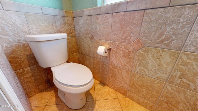 2088 Crystal Ridge St, El Paso, TX 79938 - bathroom with tile patterned floors, toilet, and tile walls