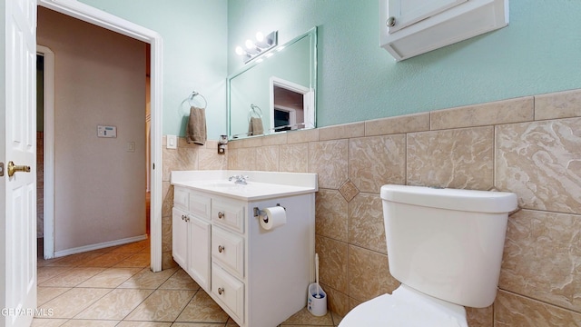 2088 Crystal Ridge St, El Paso, TX 79938 - half bathroom with vanity, tile patterned floors, toilet, and tile walls