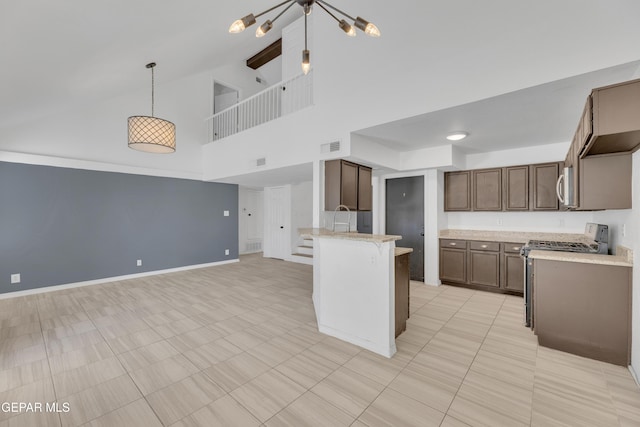 kitchen with open floor plan, a peninsula, high vaulted ceiling, light countertops, and appliances with stainless steel finishes