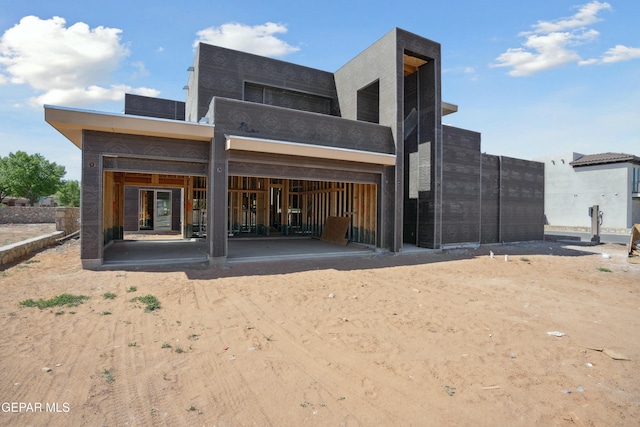 rear view of property with a garage