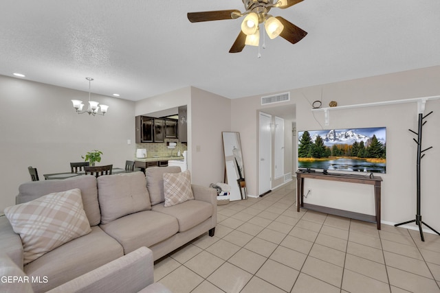 living room featuring recessed lighting, ceiling fan with notable chandelier, baseboards, visible vents, and light tile patterned flooring