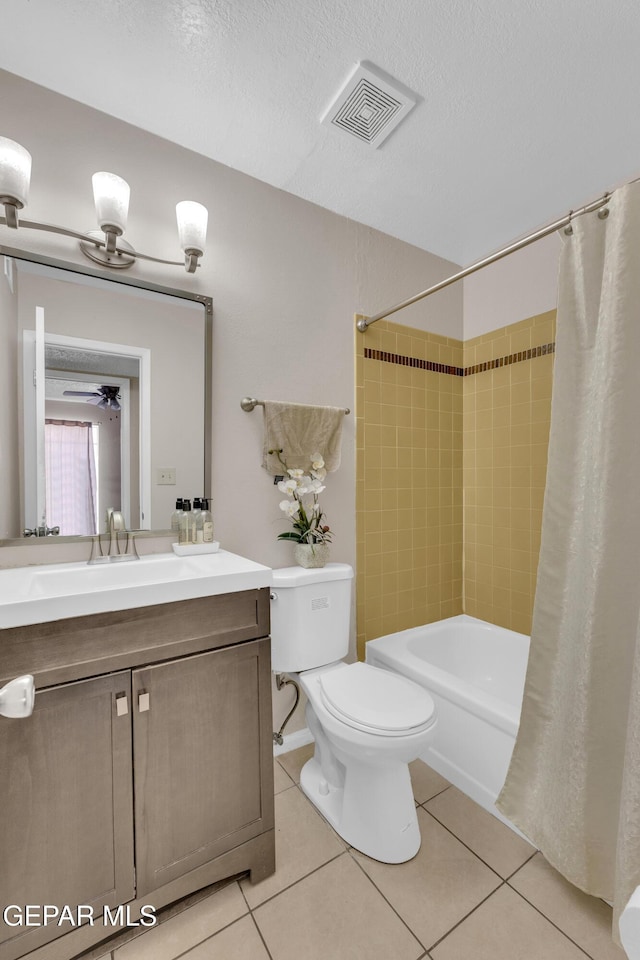 bathroom featuring tile patterned floors, toilet, vanity, visible vents, and shower / tub combo