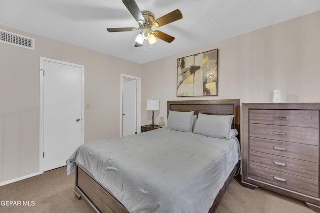 carpeted bedroom featuring visible vents and ceiling fan