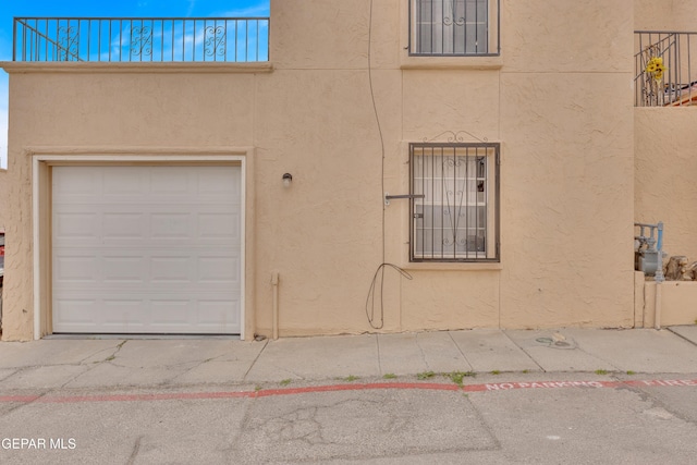 view of property exterior featuring a garage and stucco siding