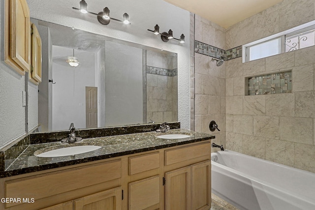 full bathroom with double vanity,  shower combination, and a sink