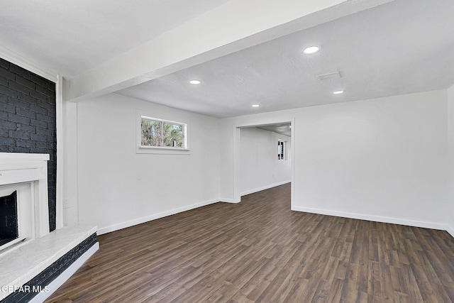 interior space with a brick fireplace, recessed lighting, wood finished floors, and baseboards