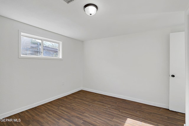 unfurnished room featuring dark wood-style floors and baseboards