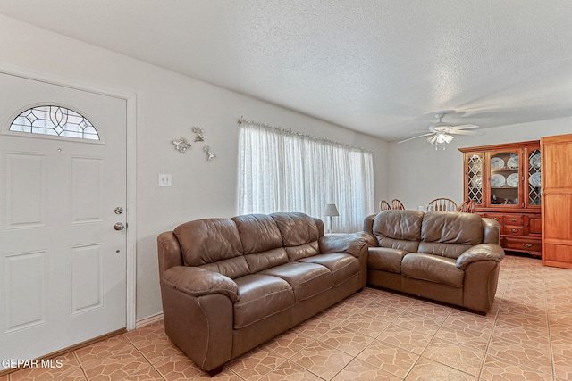 316 Garden Grove Ln, El Paso, TX 79912 - living room featuring a textured ceiling, a ceiling fan, and a healthy amount of sunlight
