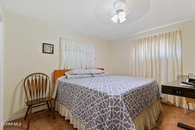 316 Garden Grove Ln, El Paso, TX 79912 - bedroom with ceiling fan, tile patterned flooring, and baseboards
