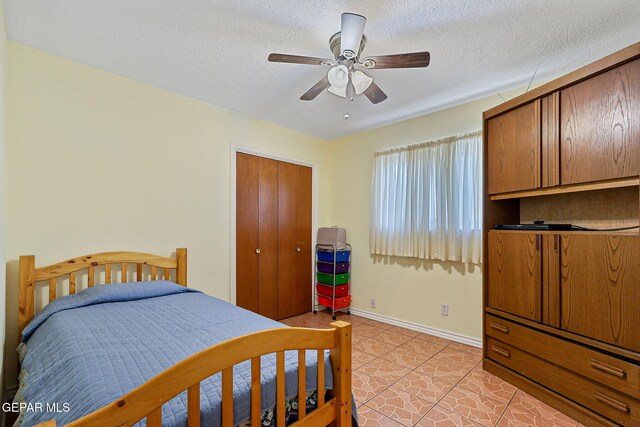 316 Garden Grove Ln, El Paso, TX 79912 - bedroom with baseboards, ceiling fan, a textured ceiling, and light tile patterned flooring