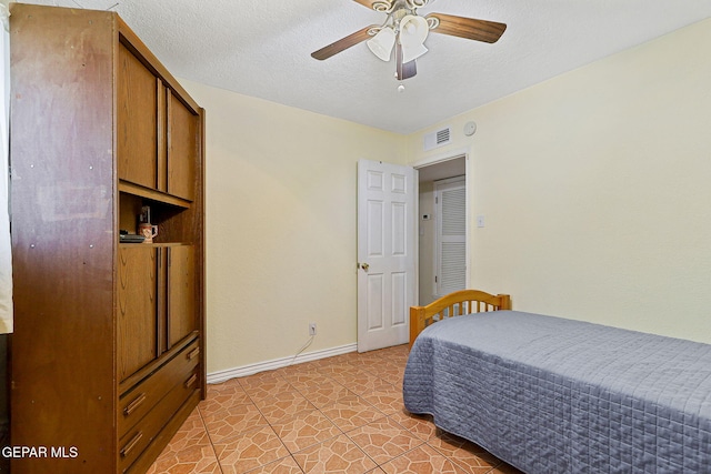 316 Garden Grove Ln, El Paso, TX 79912 - bedroom with a textured ceiling, visible vents, a ceiling fan, and baseboards