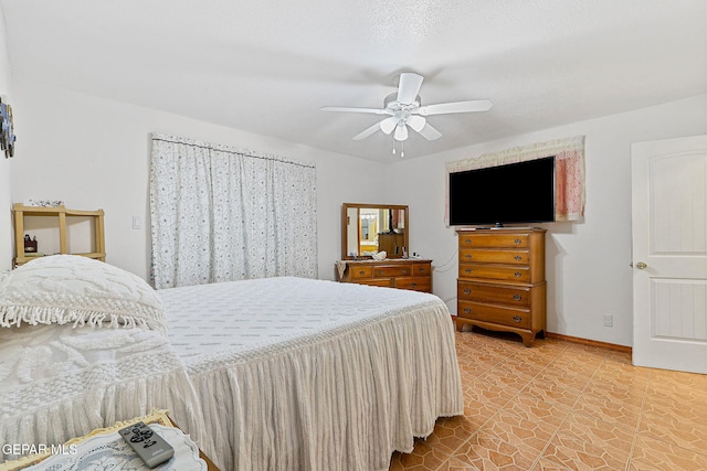316 Garden Grove Ln, El Paso, TX 79912 - bedroom with light tile patterned floors, a ceiling fan, and baseboards